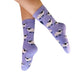 Purple socks with sheep pattern worn by a person on a white background