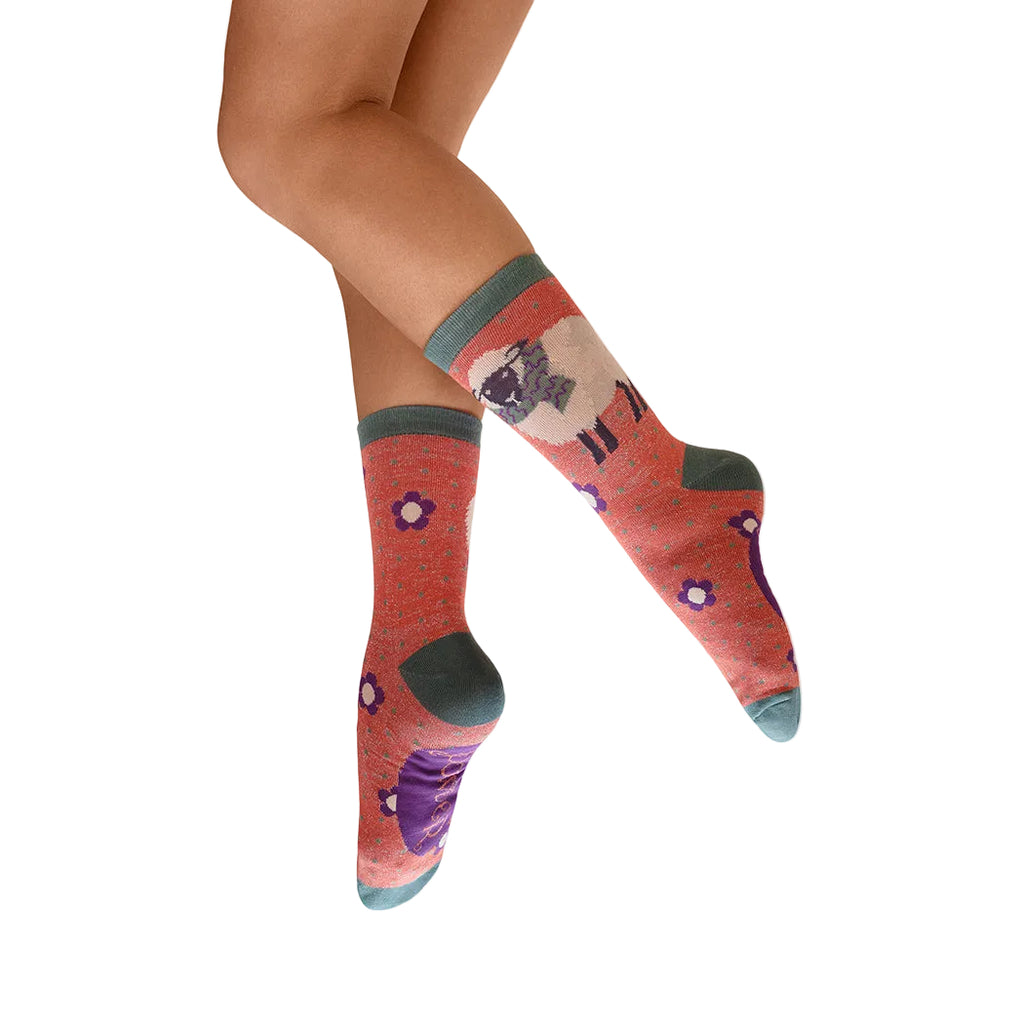 Colorful socks with animal design worn by a person on a white background