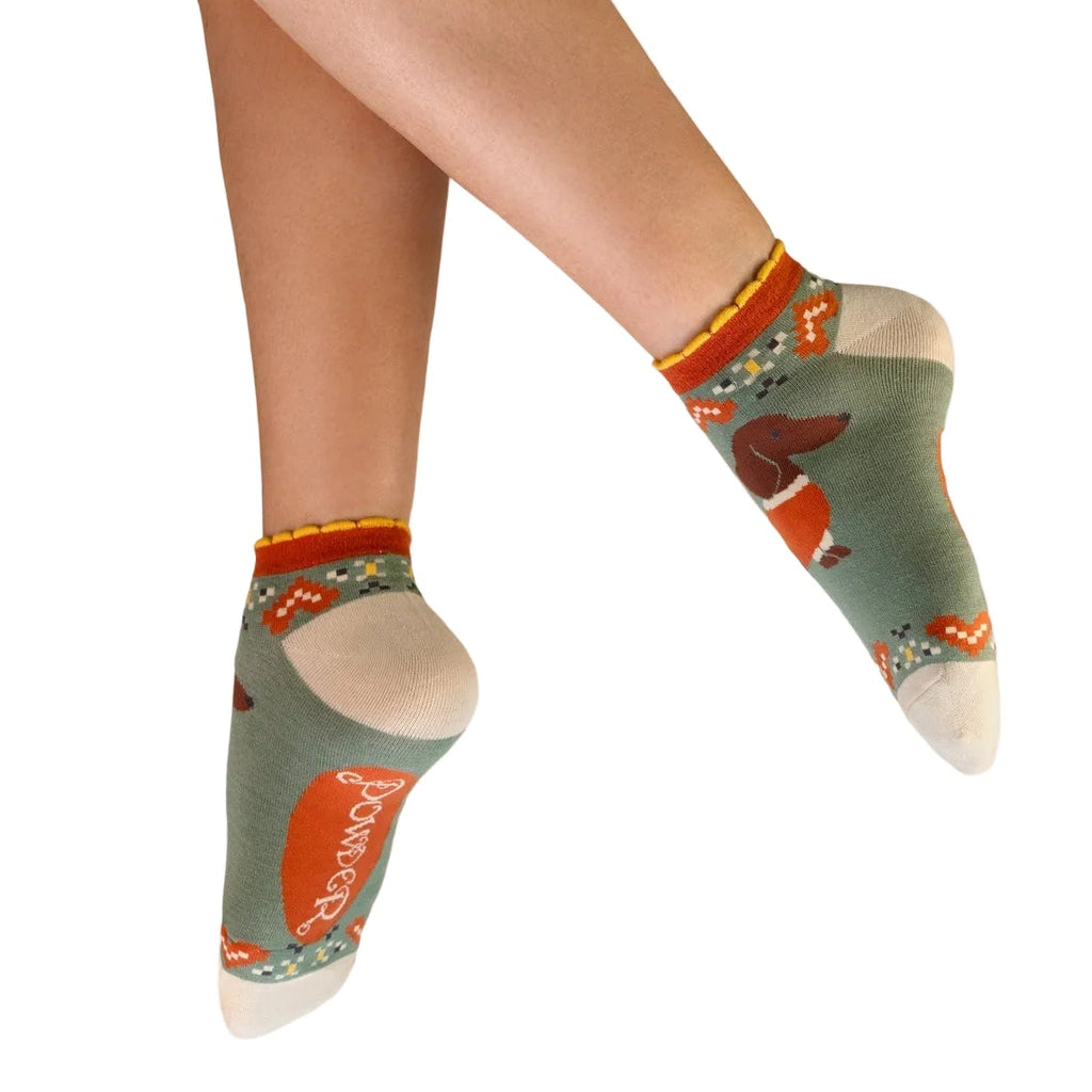 Person wearing patterned socks with a white background