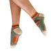 Person wearing patterned socks with a white background