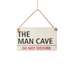 Sign with 'The Man Cave Do Not Disturb' text on a white background