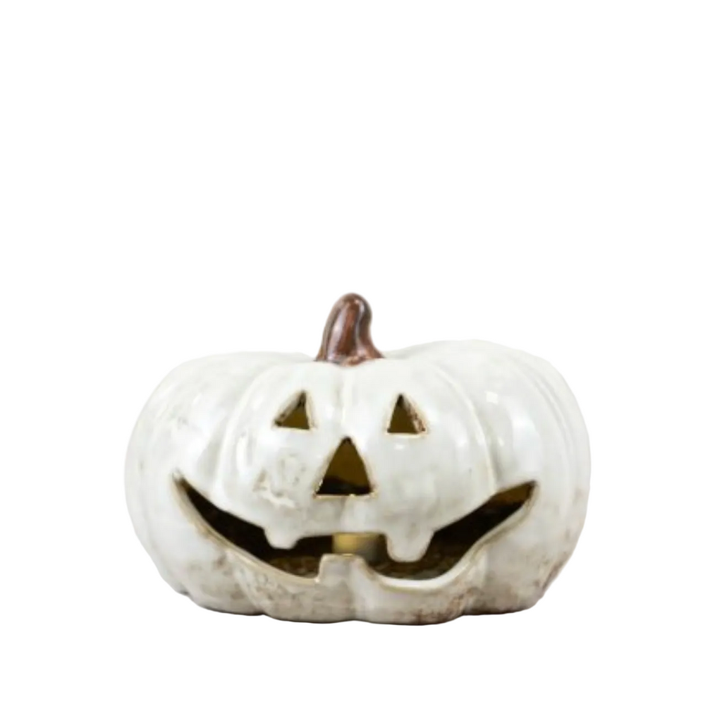 white ceramic pumpkin tea light holder on a white background