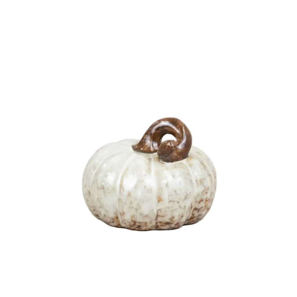 glazed cream and brown ceramic pumpkin on a white background