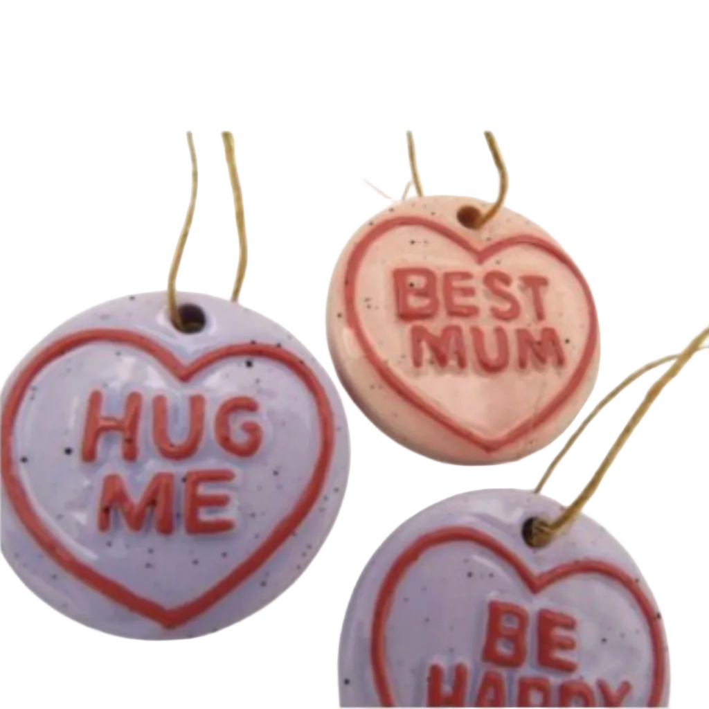 ceramic love heart hanging decorations on a white background