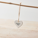 A dainty white porcelain heart featuring the sentiment "Special Mum" in a stamped typewriter-style font on a textured.