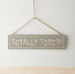 Hanging wooden sign saying 'Sotally Tober'