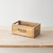Wooden box labeled 'Man Box' on a wooden surface on a wooden surface with a white background