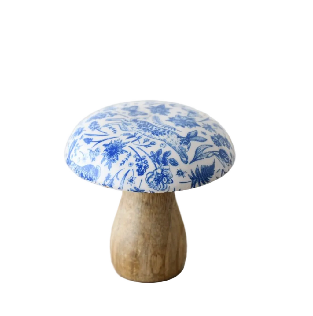 A wooden mushroom ornament with blue floral patterns on a white background 