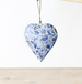 Heart-shaped decorative item with blue floral pattern on a white background