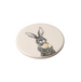 Round ceramic coaster with a rabbit illustration holding a flower on a white background