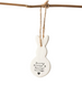 White ceramic bunny ornament with text hanging on a branch against a white background