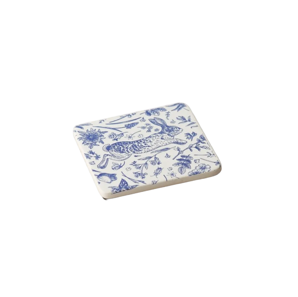 Ceramic coaster with blue floral and animal pattern on a white background