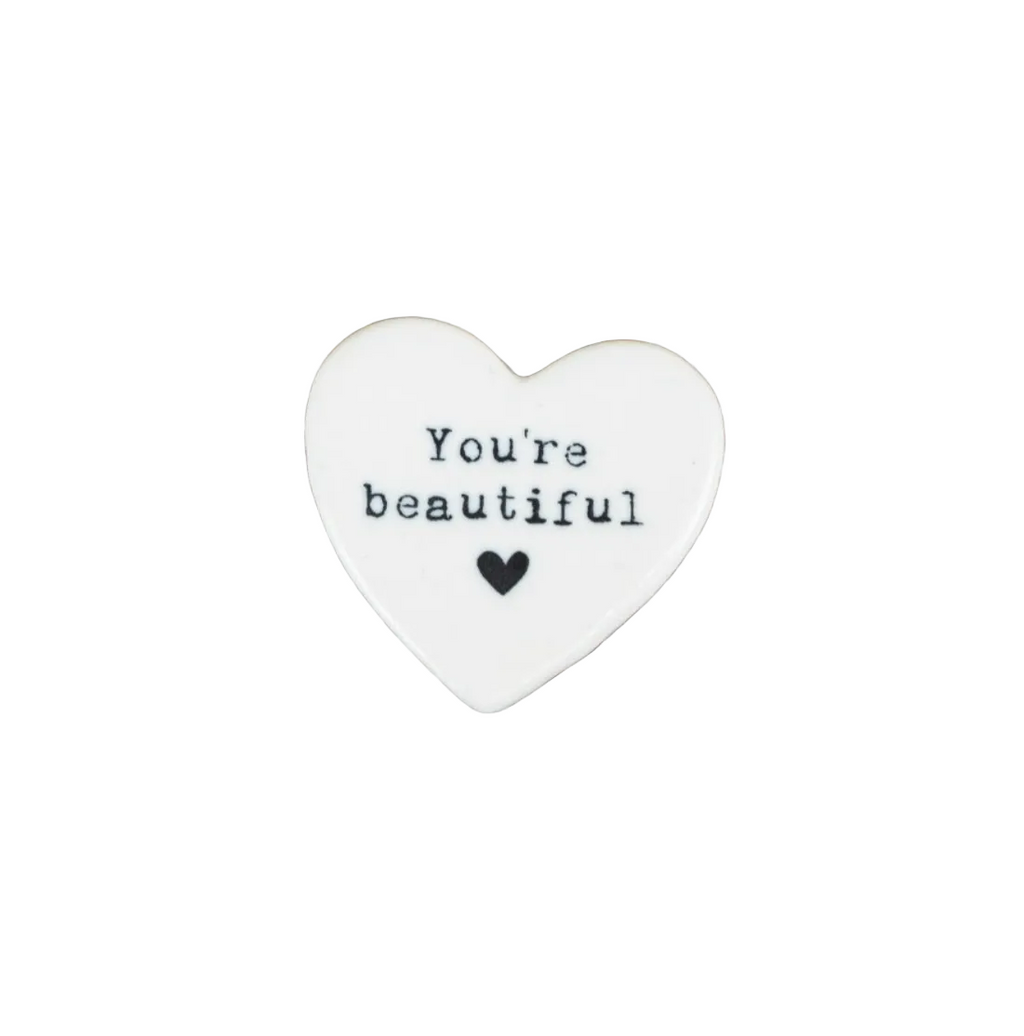 Heart-shaped stone with 'You're beautiful' text on a white background