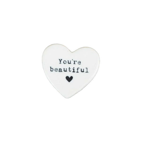 Heart-shaped stone with 'You're beautiful' text on a white background