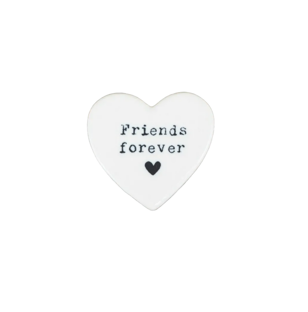 Heart-shaped stone with 'Friends forever' text on a white background