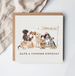 Birthday card with illustrations of dogs and text 'Have a pawsome birthday' on a white background.