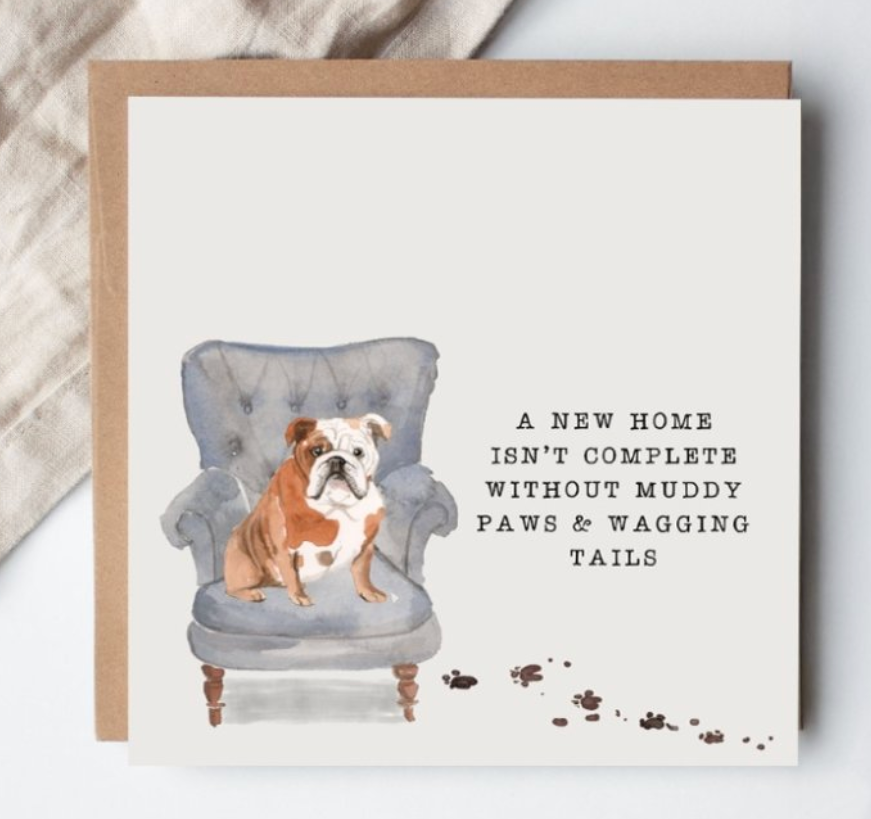 Greeting card with a bulldog on an armchair and text about a new home.