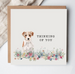 Greeting card with a dog illustration and 'Thinking of You' text on a white background.