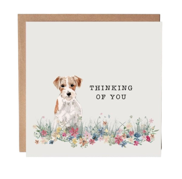 Greeting card with a dog illustration and 'Thinking of You' text on a white background.