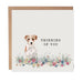 Greeting card with a dog illustration and 'Thinking of You' text on a white background.