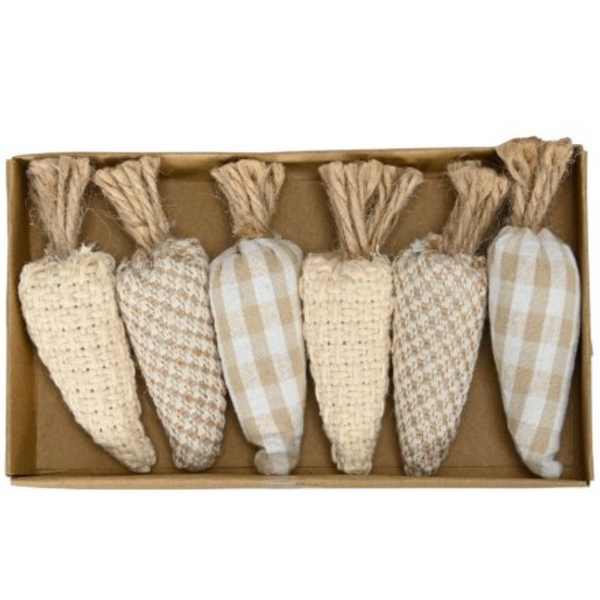 Set of decorative carrots in a cardboard box on a white background