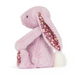Plush bunny toy with a floral inserts on a white background