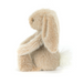 Fluffy beige bunny toy on a white background