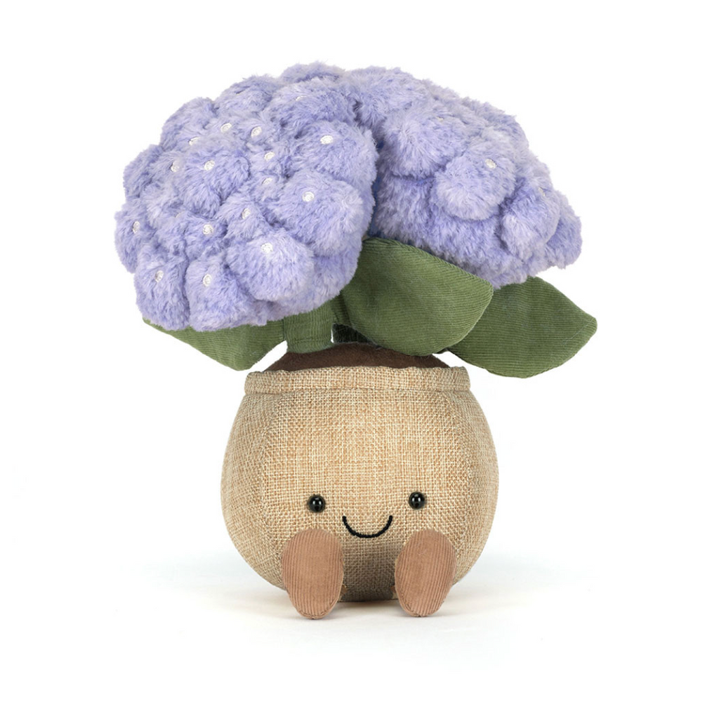 Plush toy resembling a hydrangea with a smiling face on a white background
