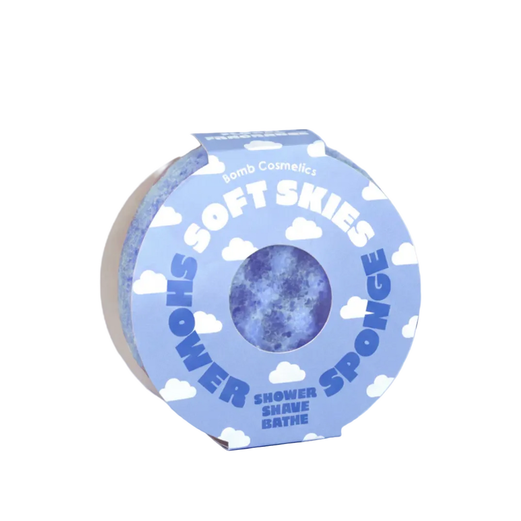 Shower sponge with 'Soft Skies' packaging on a cloud-themed background