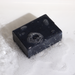 Black soap bar with bubbles on a white background