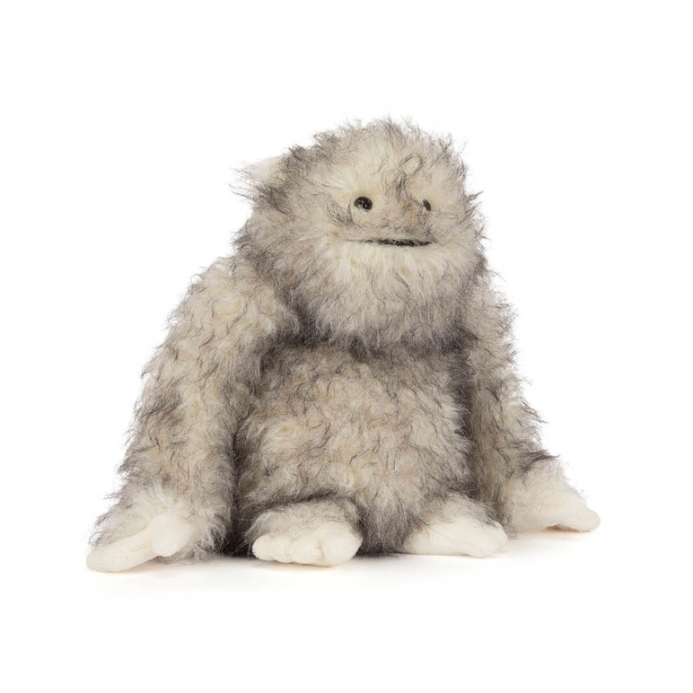 Plush toy resembling a gray creature on a white background