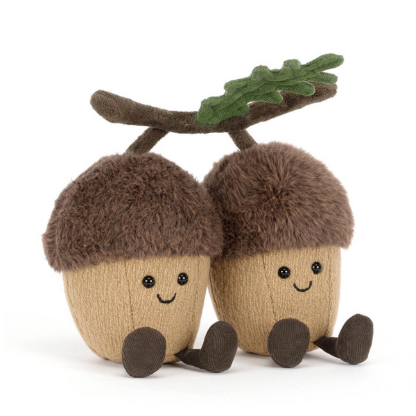 Two plush acorns with faces on a white background