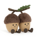 Two plush acorns with faces on a white background