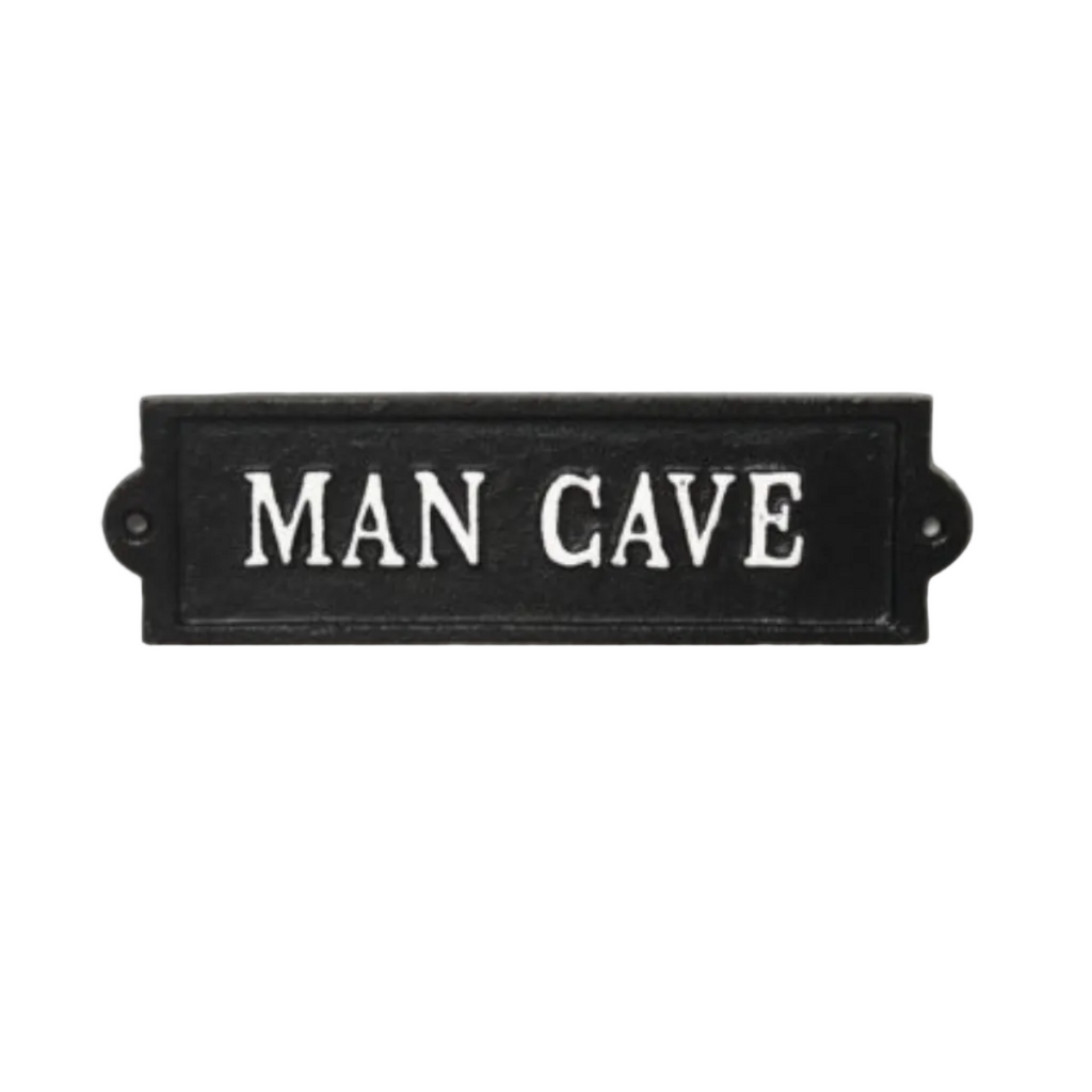 Black sign with 'MAN CAVE' text on a white background