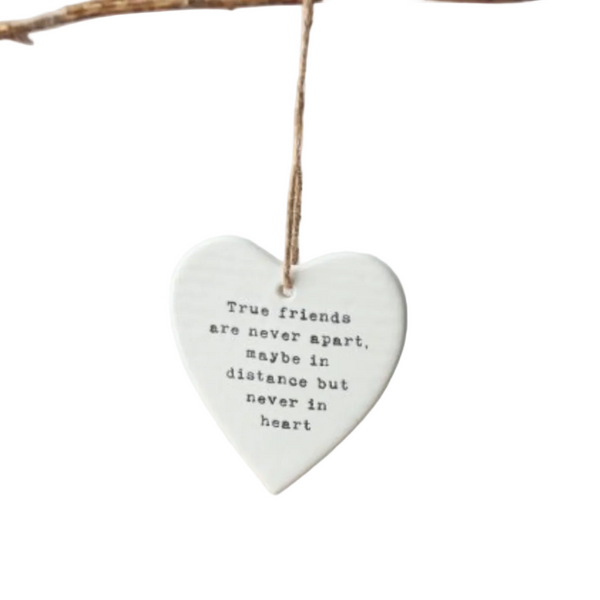 Heart-shaped hanging ornament with a quote on a white background