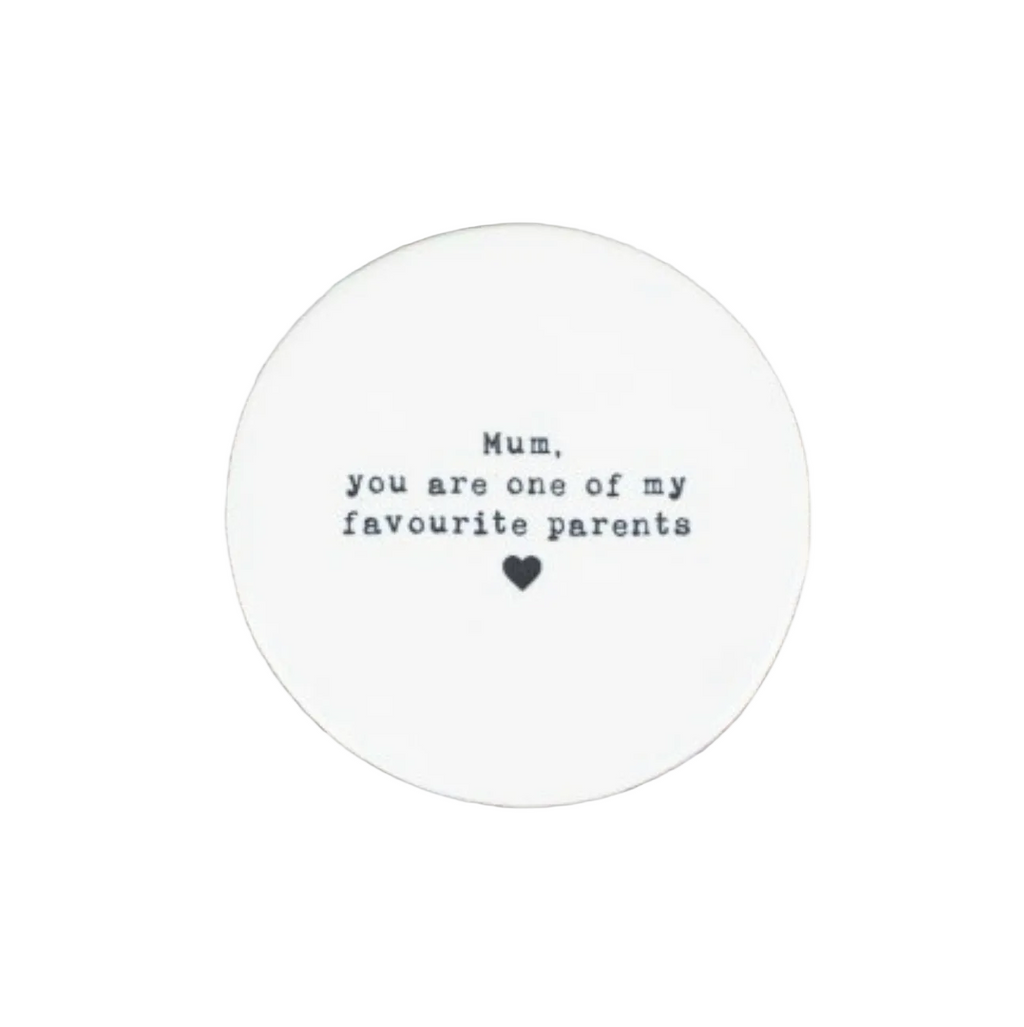 Round white coaster with text on a white surface