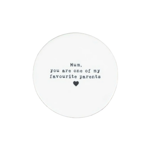 Round white coaster with text on a white surface