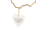 Heart-shaped white plaque with text hanging on a branch against a white background