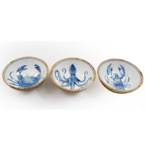 Three ceramic dishes with blue sea creature designs on a white background
