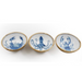 Three ceramic dishes with blue sea creature designs on a white background