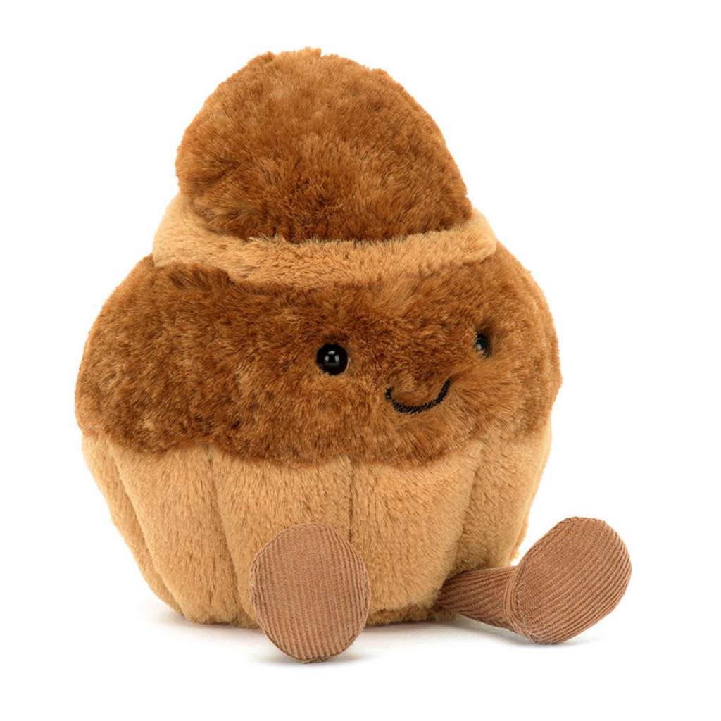 Plush toy resembling a brown acorn with a smiling face on a white background