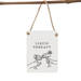 A rectangular white hanging sign with a rustic twine loop and wooden grommets, featuring the text 'LIQUID THERAPY' above a simple black line drawing of two hands clinking cocktail glasses. The sign hangs from a natural wood rod against a light gray background.