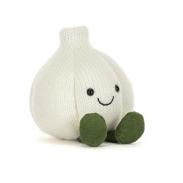 A knitted garlic plush toy with a smiling face and olive green feet, photographed on a clean white background.