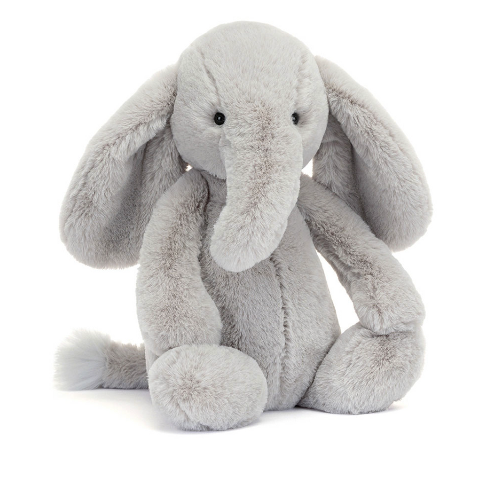 A light gray plush elephant toy with long floppy ears, a long trunk, and small black eyes, sitting against a plain white background.
