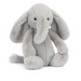 A light gray plush elephant toy with long floppy ears, a long trunk, and small black eyes, sitting against a plain white background.