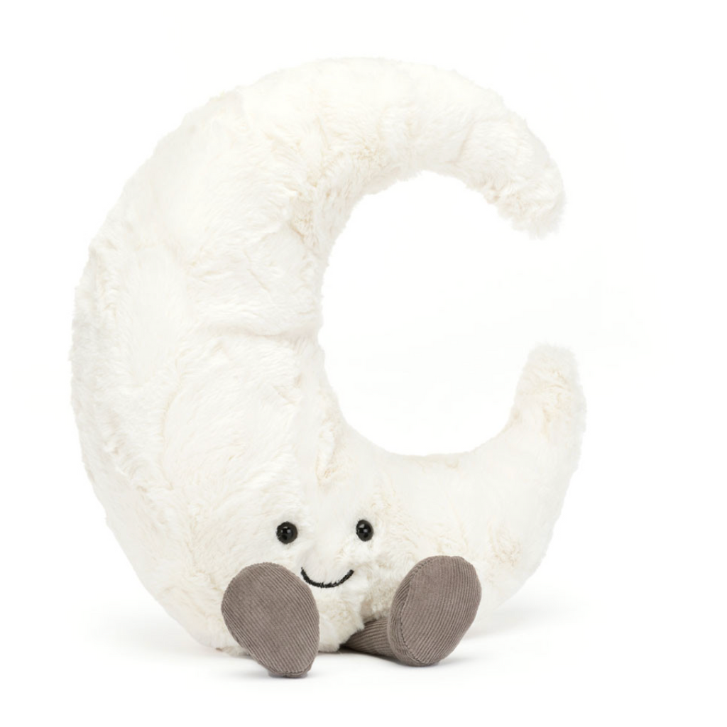 A plush crescent moon letter C toy in soft white faux fur, featuring a small embroidered smiley face and brown fabric feet, shown on a plain white background.