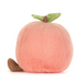 A plush peach toy shown from the back, featuring soft pink faux fur, a green fabric leaf, and a brown stem, photographed on a clean white background.