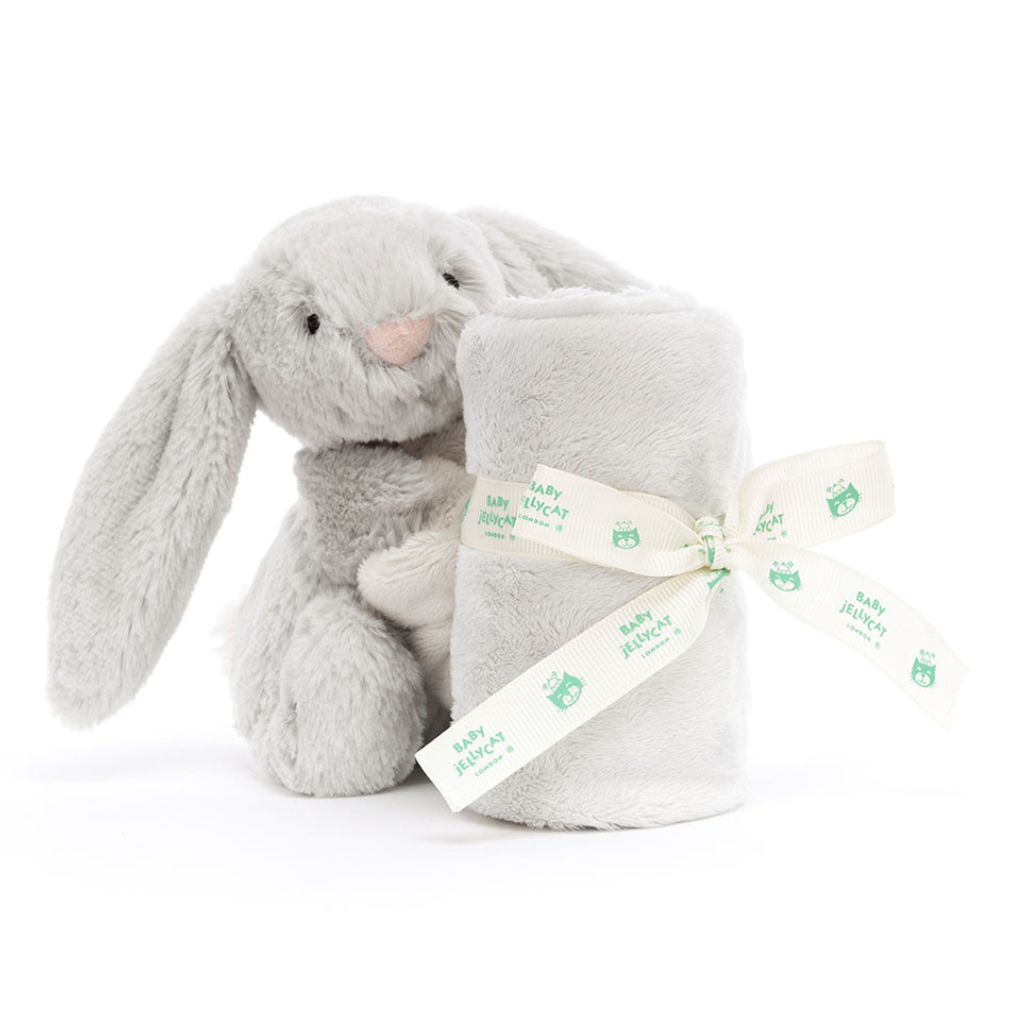 A light gray plush bunny toy holding a matching rolled gray blanket tied with a cream ribbon printed with the Baby Bellroy logo, photographed on a clean white background.