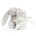 A light gray plush bunny toy holding a matching rolled gray blanket tied with a cream ribbon printed with the Baby Bellroy logo, photographed on a clean white background.