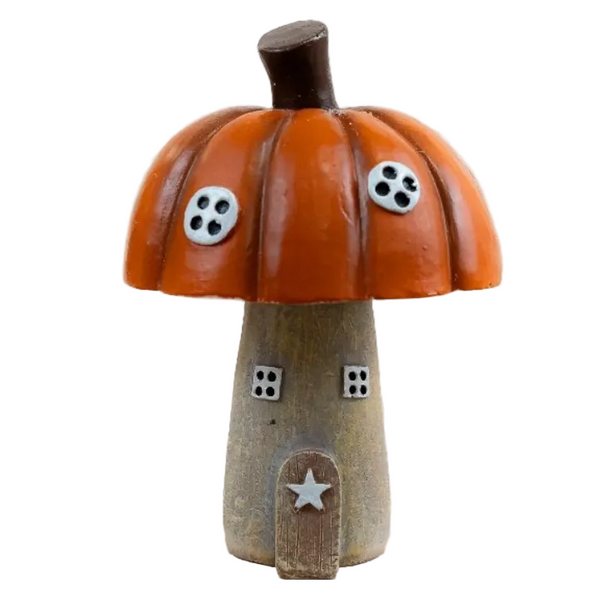 A small decorative mushroom-shaped house figurine with an orange-brown pumpkin cap, a tan wooden-looking stem, and tiny black-and-white window details, on a white background.